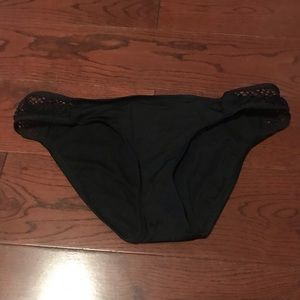 Black bikini bottoms with cutouts.
